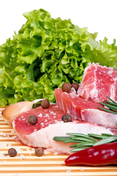 Raw meat, vegetables and spices on wooden board — Stock Photo, Image