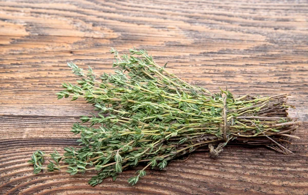 Bunch of fresh thyme on a wooden board — Stock Photo, Image