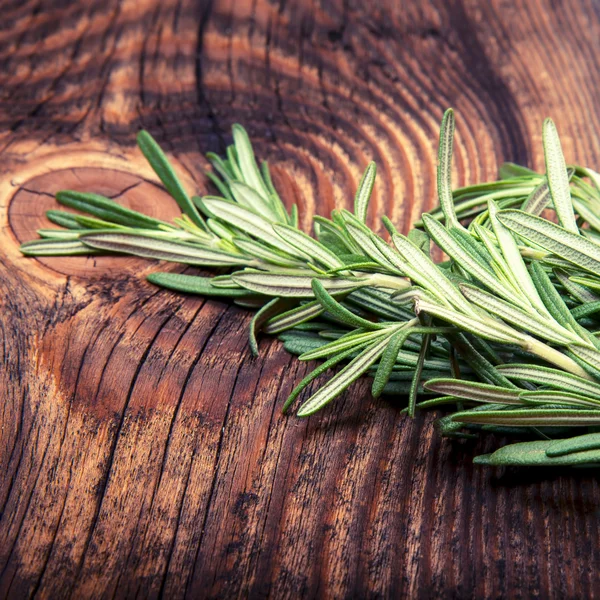 Fresh rosemary bound on a wooden board — Stock Photo, Image