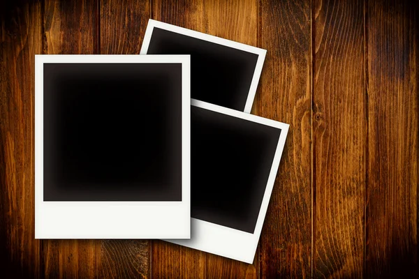 Photo frames on wooden board background texture — Stock Photo, Image