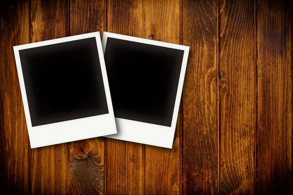 Photo frames on wooden board background texture — Stock Photo, Image