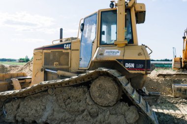 Excavator in quarry extracting stone, soil ground