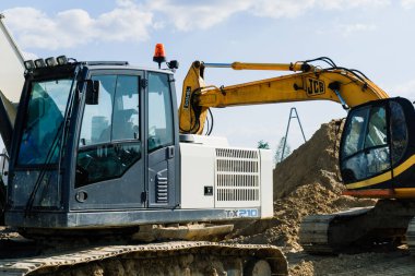 Excavator in quarry extracting stone, soil ground