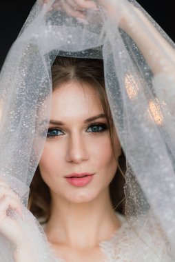 Beautiful bride in white lace lingerie in hotel room. Happy wedding morning.