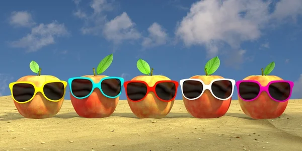 five apples with colourful sunglasses at the beach