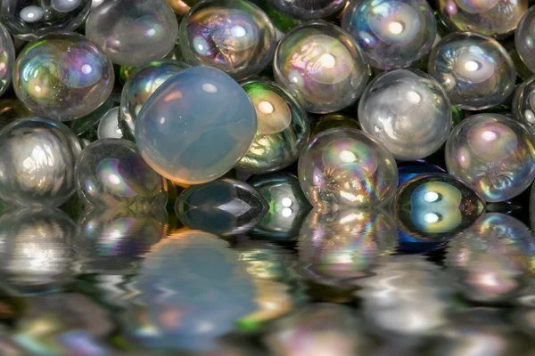 Sunken iridescent glass beads — Stock Photo, Image