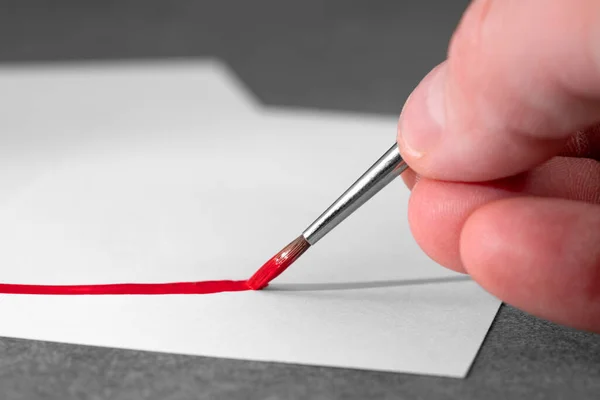 Closeup Shot Hand Holding Paintbrush Painting Red Line White Paper — Stock Photo, Image