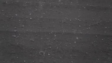 Slow motion of hail storm hitting roof during a bad weather summer storm