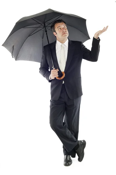 Zakenman beschermd door een paraplu — Stockfoto