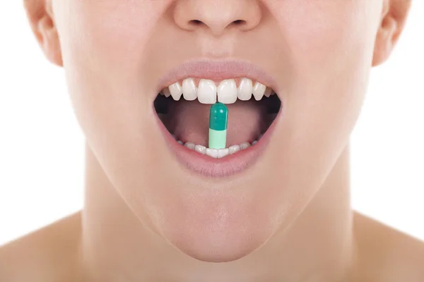 Open mouth with pill between teeth — Stock Photo, Image