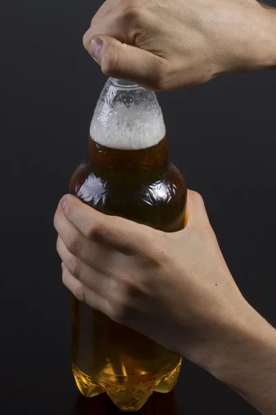 Ein Mann öffnet eine Flasche Bier — Stockfoto