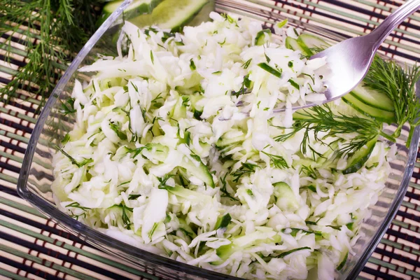 Salad from cabbage with a cucumber and greens — Stock Photo, Image
