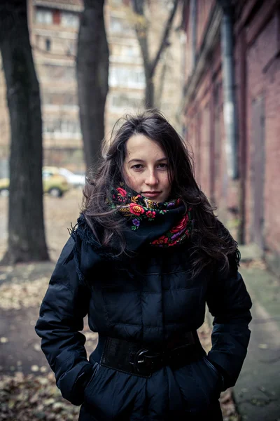 Beautiful girl standing outdoors in an ethnic style scarf — Stock Photo, Image