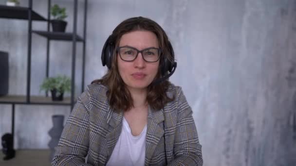 Portrait of beautiful live streaming podcast at home. She using microphone to work at room — Video