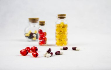 İlaçlar ve ilaçlar masanın üstünde. Şeffaf şişe ve kapsüller.