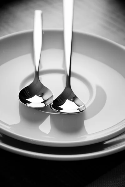 Spoon on a plate in sepia — Stock Photo, Image