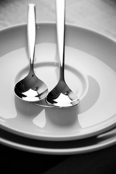 Spoon on a plate in sepia — Stock Photo, Image