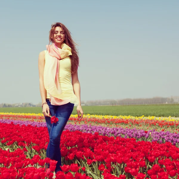 Mulher no campo de tulipa vermelha — Fotografia de Stock