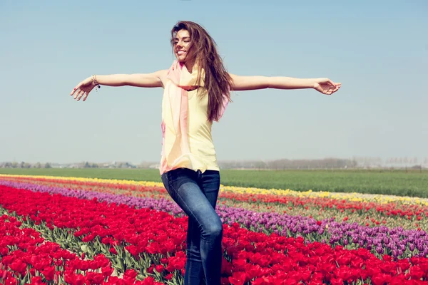 Woman in red tulip field — Stock Photo, Image