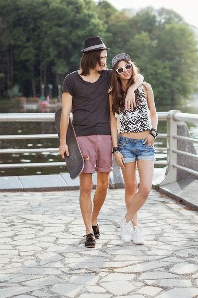 Yong couple on the bank of a river — Stock Photo, Image