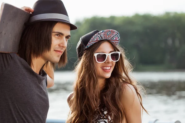 Yong couple on the bank of a river — Stock Photo, Image