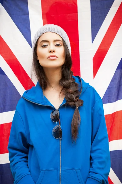 Beautiful young brunette woman with british flag — Stock Photo, Image