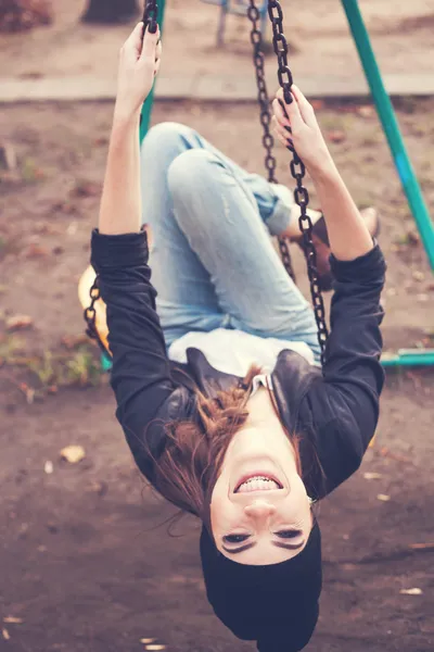 Gentle portrait of a beautiful girl on a swing — Stock Photo, Image