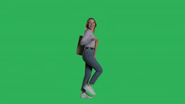 Young woman in casual clothes walks with shopping bag — Stock videók