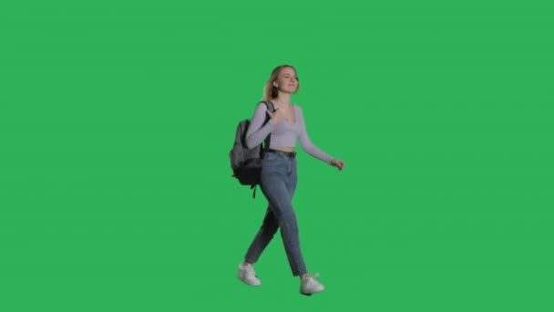 Happy young female model walking with backpack — Wideo stockowe