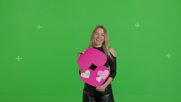 Girl holding heart-shaped card Valentines Day — стокове відео