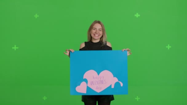 Girl holding large paper poster Valentines Day — стокове відео