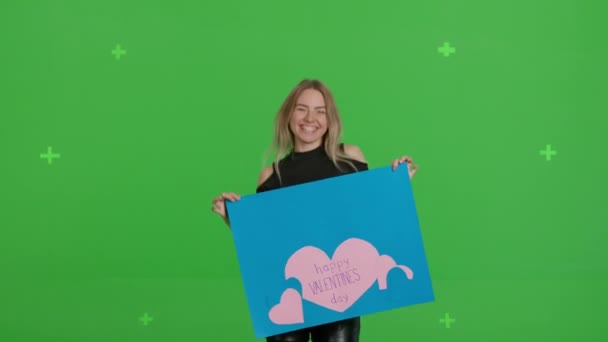 Girl holding large paper poster Valentines Day — Vídeo de Stock