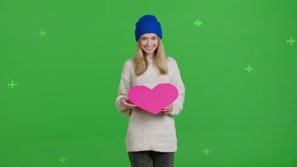 Girl holding heart-shaped card Valentines Day — стоковое видео