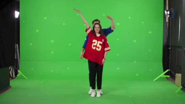 Young couple is dancing on a green screen background — Stock Video