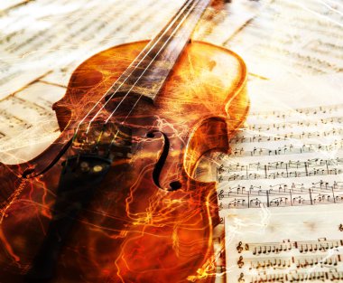 Old violin lying on the sheet of music clipart