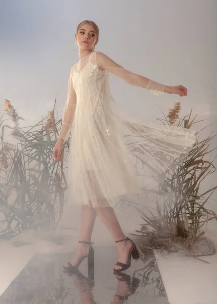 Beyaz elbiseli katalog için güzel bir sarışın.