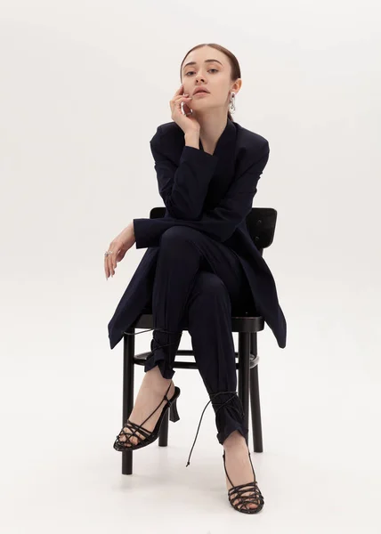 Stylish Cheeky Girl Pantsuit Sits Chair — стоковое фото