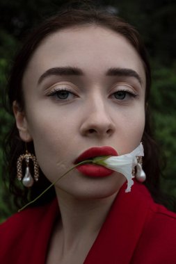 sensual portrait of a brunette with a delicate flower