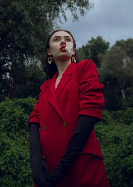 Beautiful Girl Red Coat Fashionable Earrings Stands Forest — Stock fotografie
