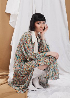 gentle girl in a long vintage dress posing on the floor