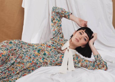 gentle girl in a long vintage dress posing on the floor