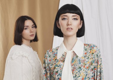 cute portrait of two brunettes in spring clothes