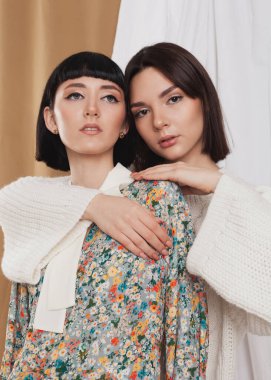 cute portrait of two brunettes in spring clothes