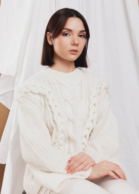 gentle portrait of a girl in a light sweater