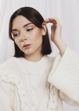 gentle portrait of a girl in a light sweater