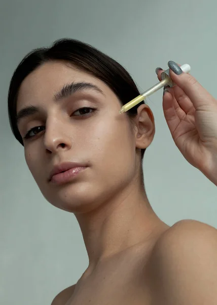 Beautiful Brunette Applying Face Serum — Stock Photo, Image