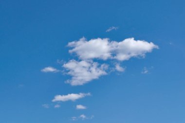 Mavi gökyüzünde beyaz kabarık bulutlar. Beyaz kümülüs bulutlarıyla mavi yaz gökyüzü.