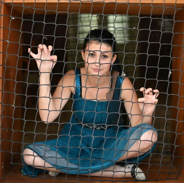 Girl behind bars — Stock Photo, Image