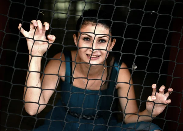 Girl behind bars — Stock Photo, Image