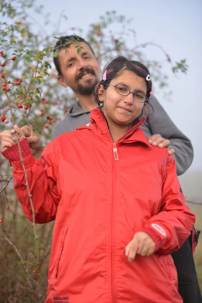 Couple picking up wild rose hip — Stock Photo, Image